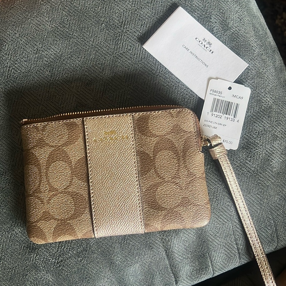 Coach wristlet NWT signature/metallic. Beautiful wristlet.